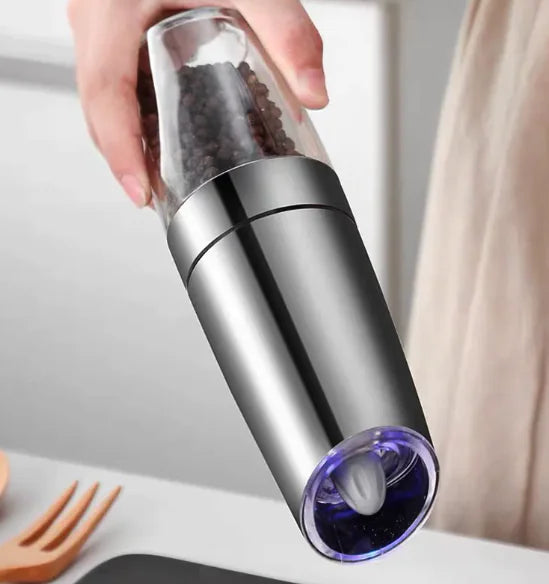 Electric gravity pepper grinder with LED in use